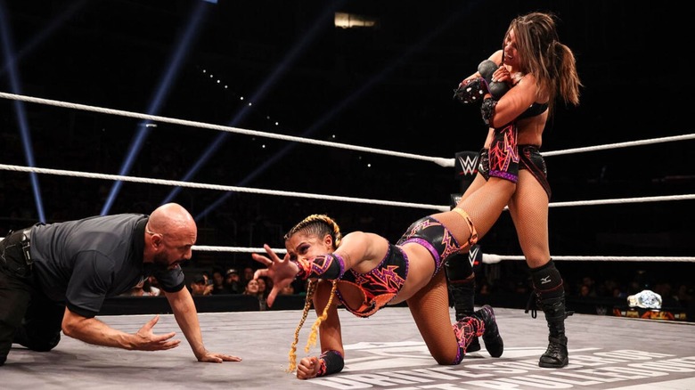 Kendal Grey puts Kelani Jordan in an ankle lock as a referee looks on, during their match for the NXT Women's Championship, at 