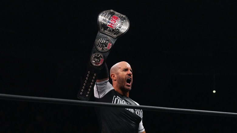 Claudio Castagnoli holding up the ROH World Championship