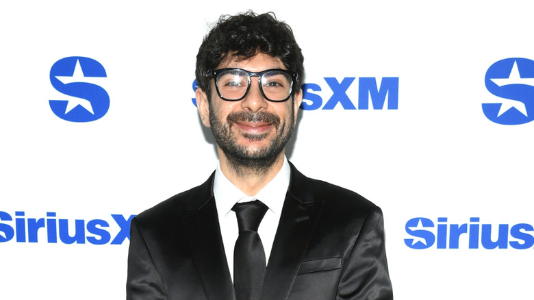 AEW President and CEO Tony Khan poses at a non-wrestling event