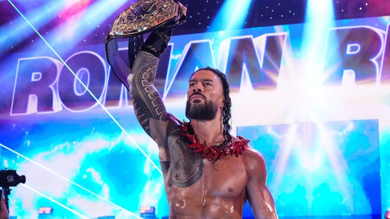 World Heavyweight Champion Roman Reigns holds the title aloft on the stage ahead of his match against Jacob Fatu at WWE Backlash 2026.