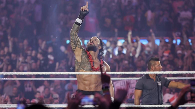 Roman Reigns points to the sky asking for fans to acknowledge him in the ring before a scheduled match