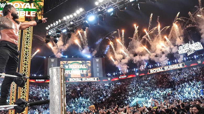 Roman Reigns pointing at WrestleMania sign after winning the Royal Rumble