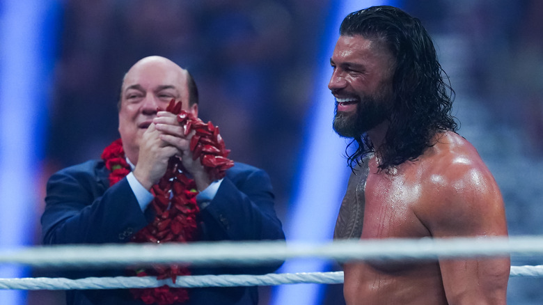 Paul Heyman and Roman Reigns sharing a laugh