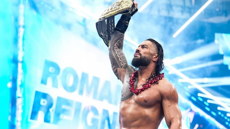 Roman Reigns hoists the World Heavyweight Championship in the ring before defending the title against Seth Rollins at WWE SummerSlam 2026.