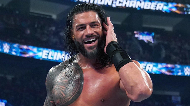 Roman Reigns listening to the fans at WWE Elimination Chamber 2023