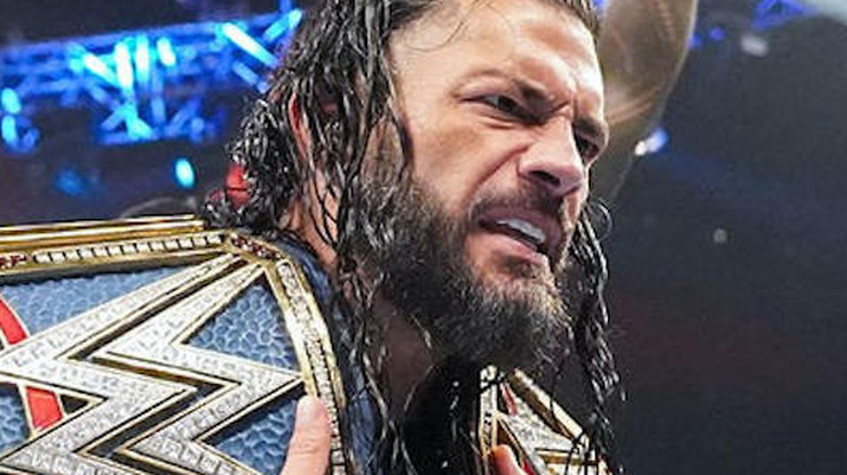 Roman Reigns with both title belts