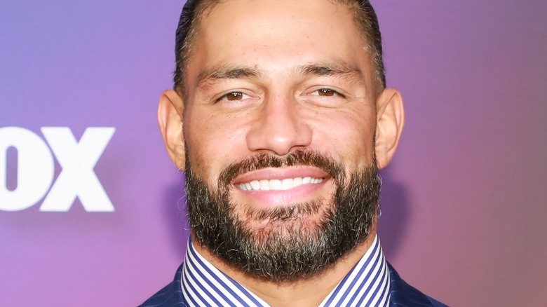 Roman Reigns smiles at a press event 