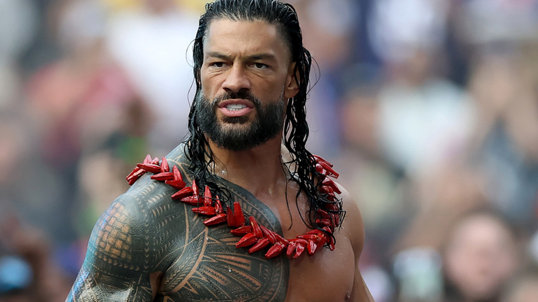 Roman Reigns learning he has to cut his vacation short