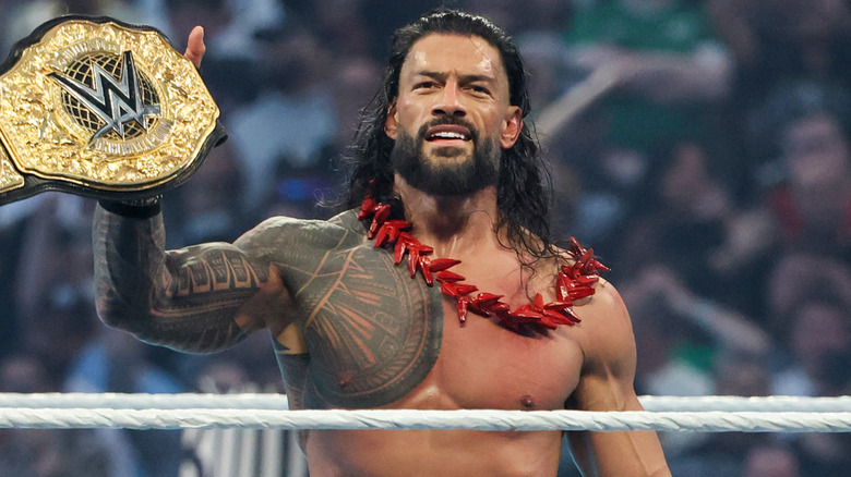 Roman Reigns celebrating with the World Heavyweight Championship after defeating CM Punk at WrestleMania 42.
