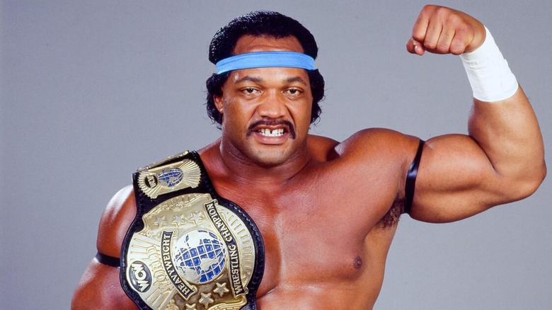 Ron Simmons posing with the WCW World Heavyweight Championship.