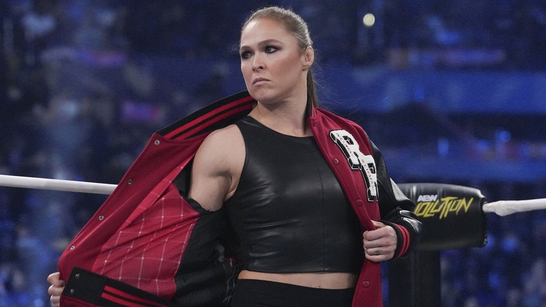 Ronda Rousey removing her jacket during her AEW Revolution appearance.
