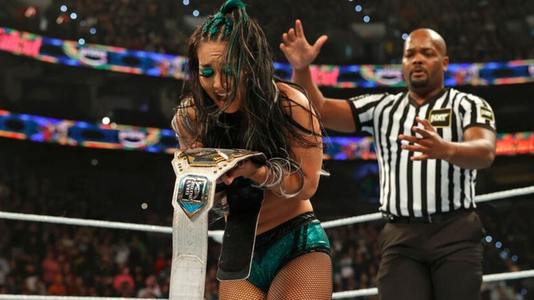 Roxanne Perez clutches the NXT Women's Championship after winning it from Lyra Valkyria at "WWE NXT" Stand & Deliver over WrestleMania weekend.