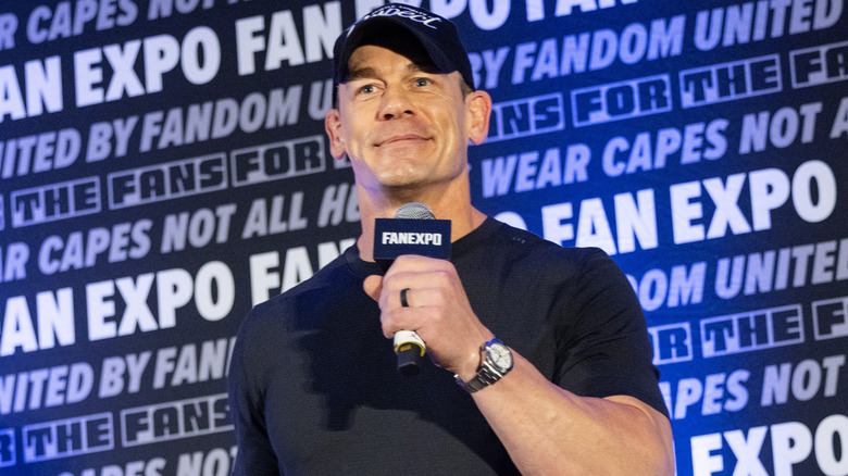 John Cena is holding a microphone