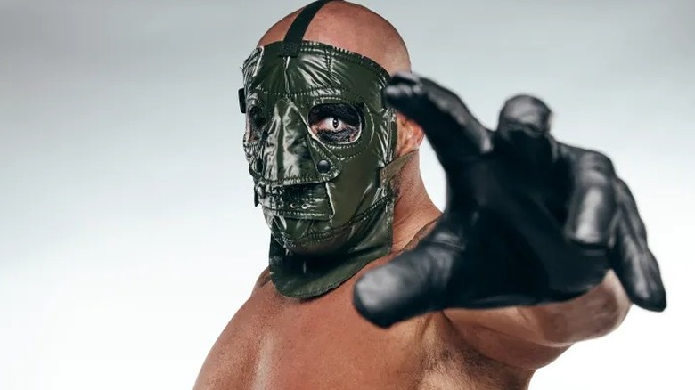 Major League Wrestling's Mads Krule Krügger (also known as Krule) reaches out towards the camera that's snapping a picture of him during a backstage photo shoot