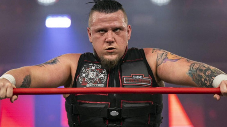 Sami Callihan leaning against the ring ropes