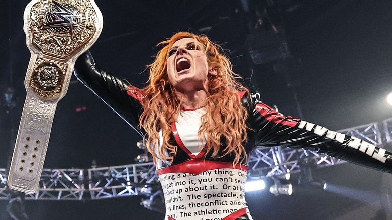 Becky Lynch celebrates winning the WWE Women's World Championship.