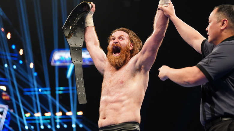 Sami Zayn shouts with joy as he holds the United States Championship.