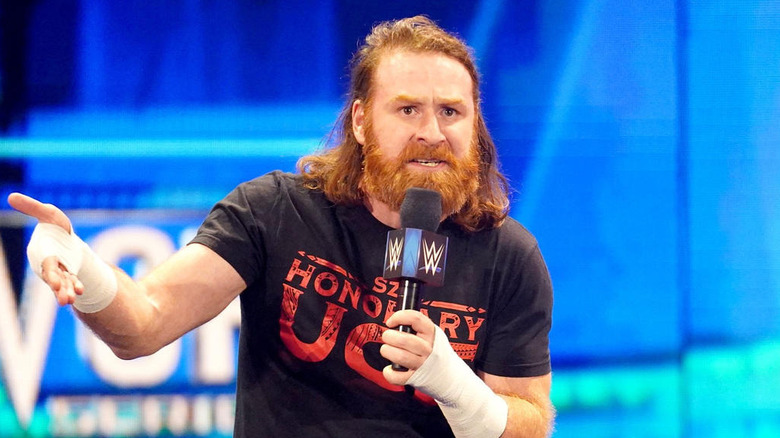 Sami Zayn holding a WWE microphone