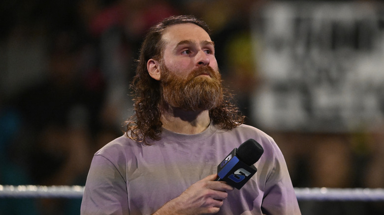 Sami Zayn with a microphone
