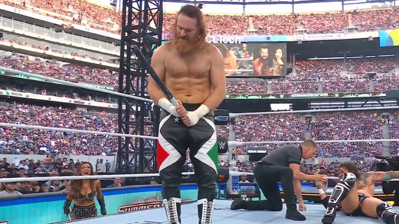 Sami Zayn holds a steel pipe