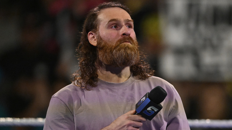 Sami Zayn holding a microphone