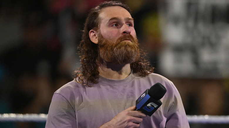 Sami Zayn holding a microphone