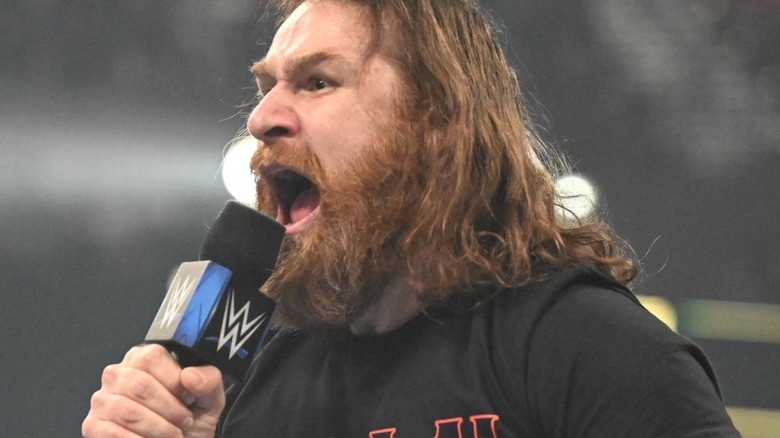 Sami Zayn yelling into a WWE microphone