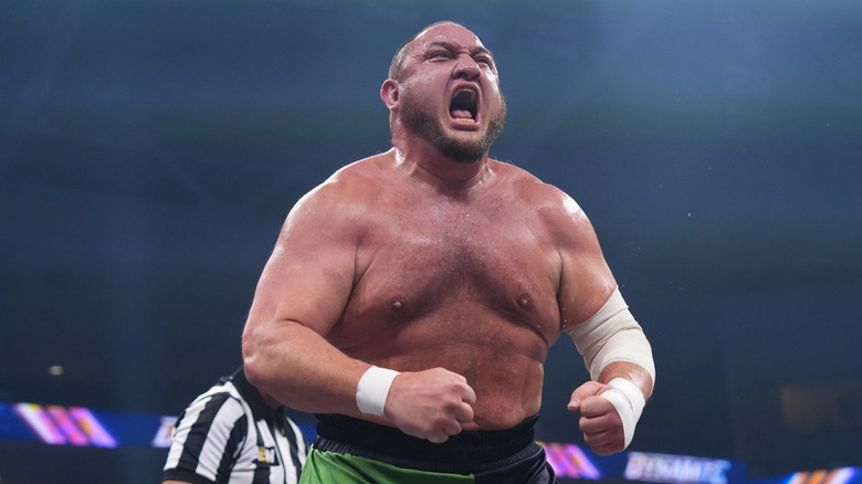 Samoa Joe flexes in the ring during a match on 