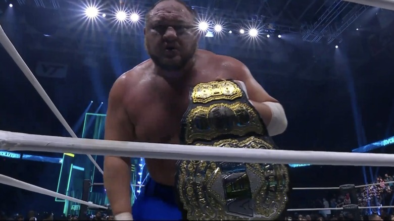 Samoa Joe holding his title
