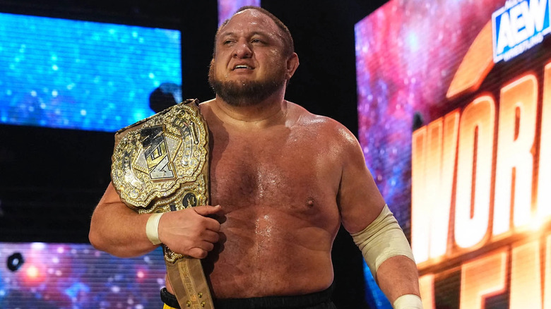 Samoa Joe holding title belt