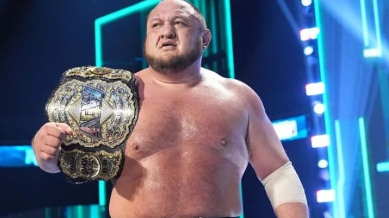 Samoa Joe with world title on his shoulder