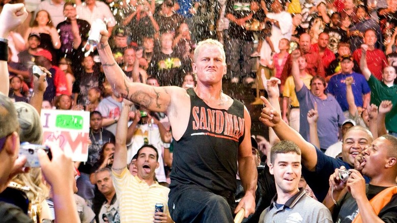 Sandman in the audience drinking beer during his entrance to the ring.