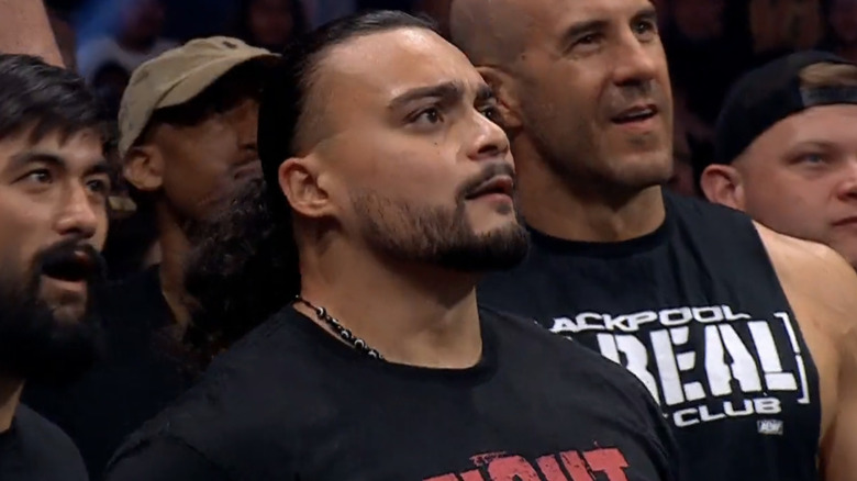 Santana, flanked by Wheeler Yuta and Claudio Castagnoli
