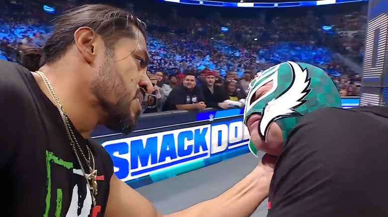 Santos Escobar grabbing Rey Mysterio's face