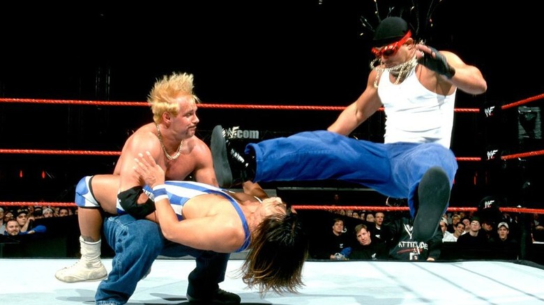 Too Cool (Scotty 2 Hotty and Grand Master Sexay) hitting a double team move on Funaki during a WWE show.
