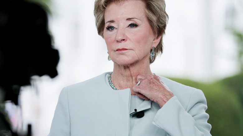 Linda mcmahon adjusting her collar