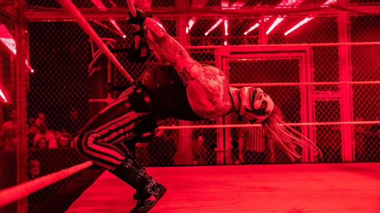WWE's Bray Wyatt hangs upside down from the ropes before a Hell In a Cell match against Seth Rollins in 2019.