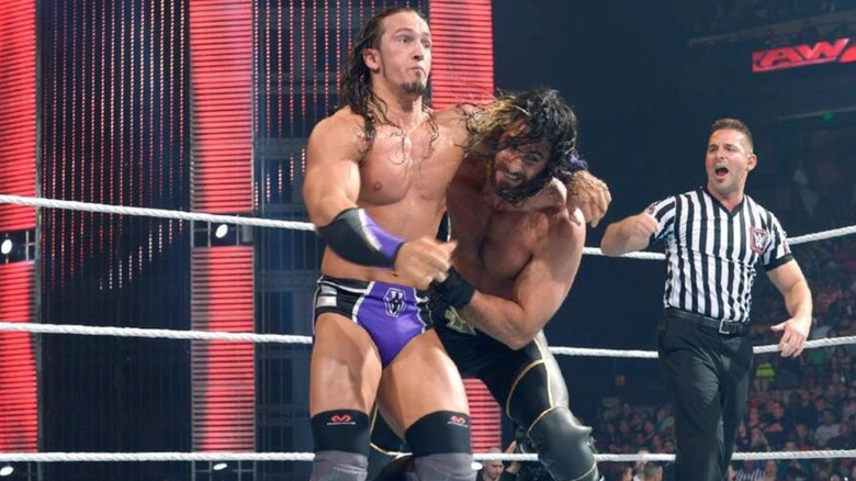 Neville, the future Pac in AEW, wrestlers against then-World Heavyweight Champion Champion Seth Rollins during a match on 