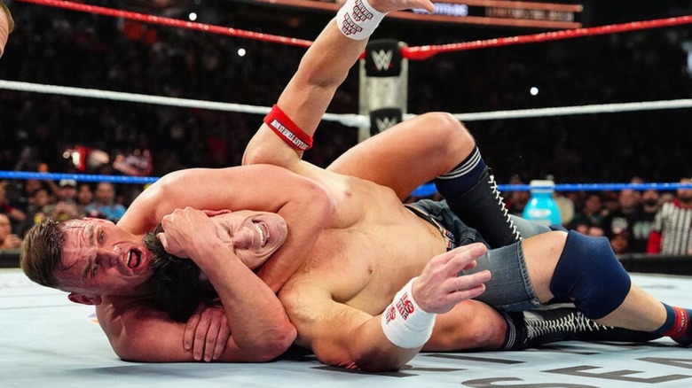 GUNTHER puts John Cena in a sleeper hold in the middle of the ring during the latter's final match at Saturday Night's Main Event.