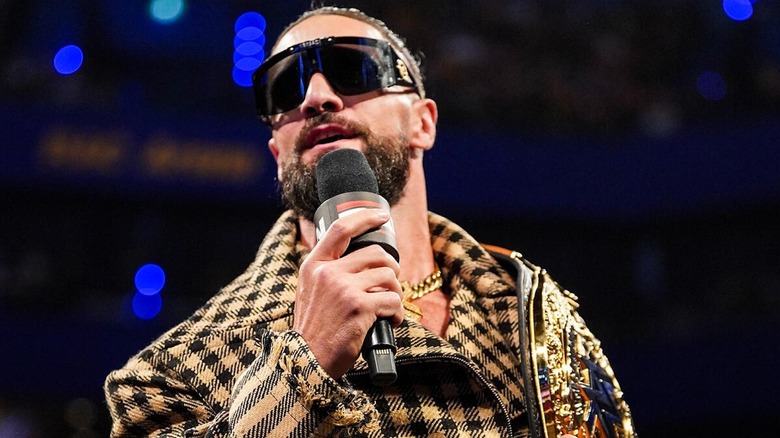 Seth Rollins poses with world title