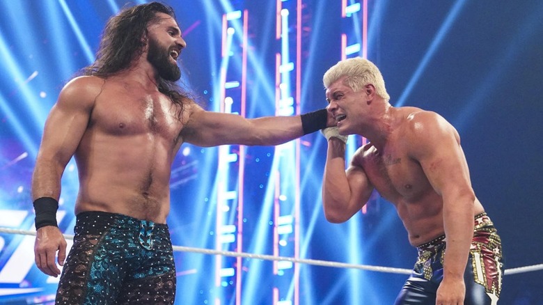 Seth Rollins holding Cody Rhodes' ear