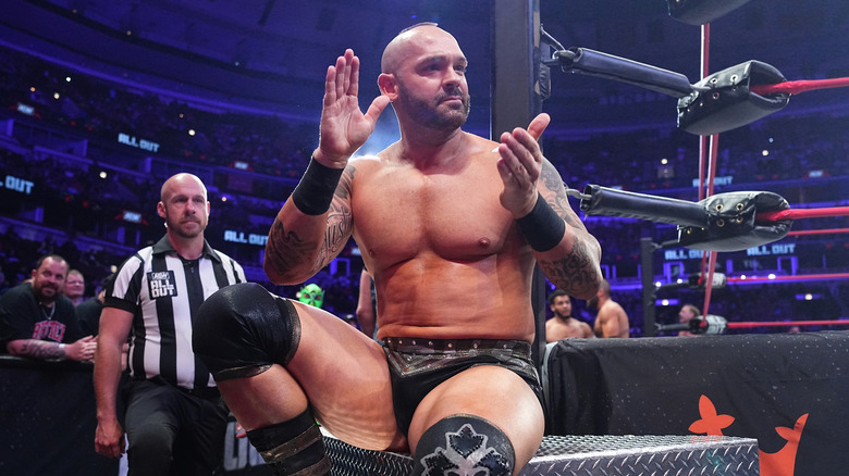 Shawn Spears applauding while sitting on the stairs