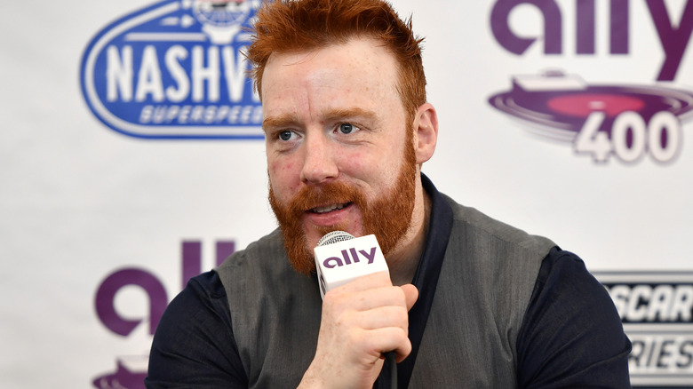 WWE star Sheamus is holding a microphone