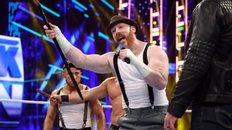 WWE's Sheamus stands in the ring, cutting a promo, shalaylee in hand.
