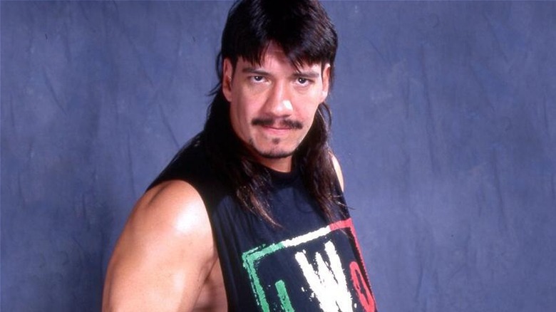 Eddie Guerrero posing with an LWO (Latino World Order) shirt during his WCW run.