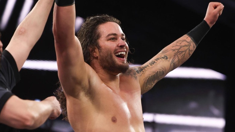 Shiloh Hill has his arm raised by a referee following a victory on 