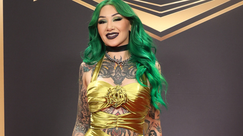 Shotzi wearing a gold dress