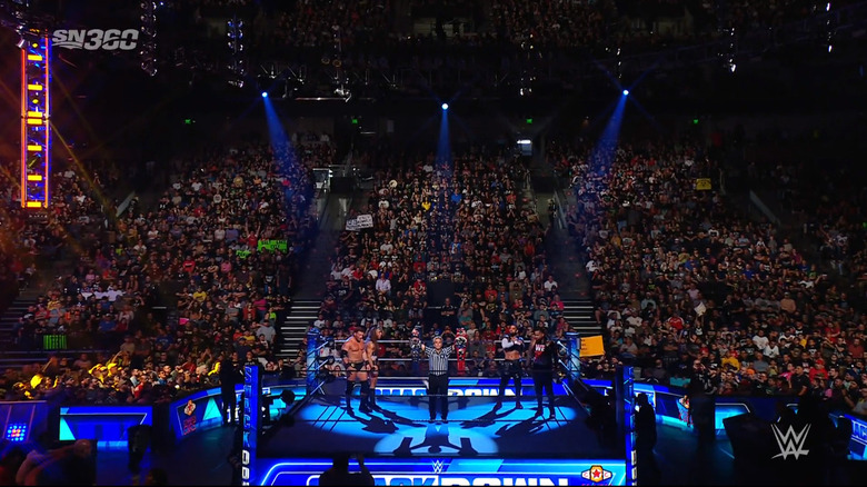The referee holding up the titles