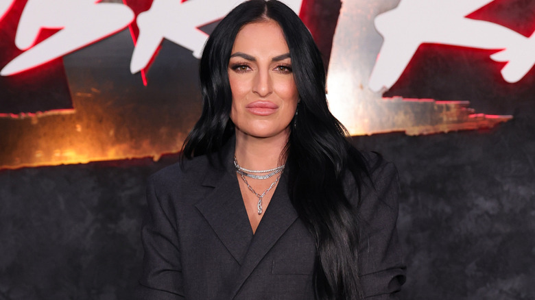 Sonya Deville wearing a silver necklace