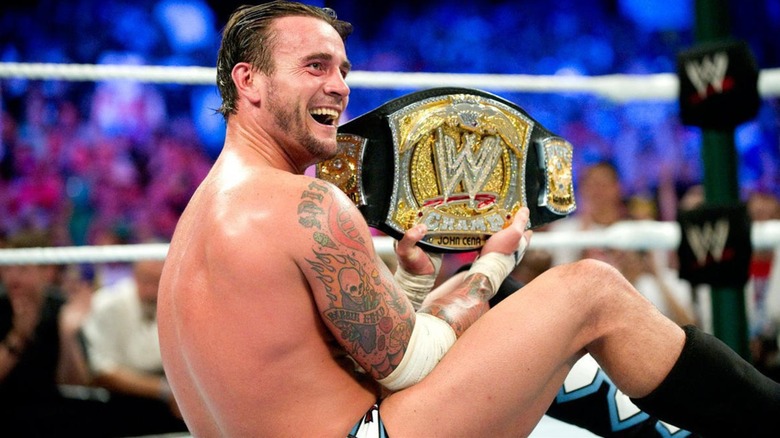 CM Punk Poses As WWE Champion